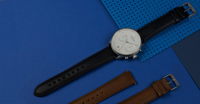 Vegan watch strap in black and brown on blue background